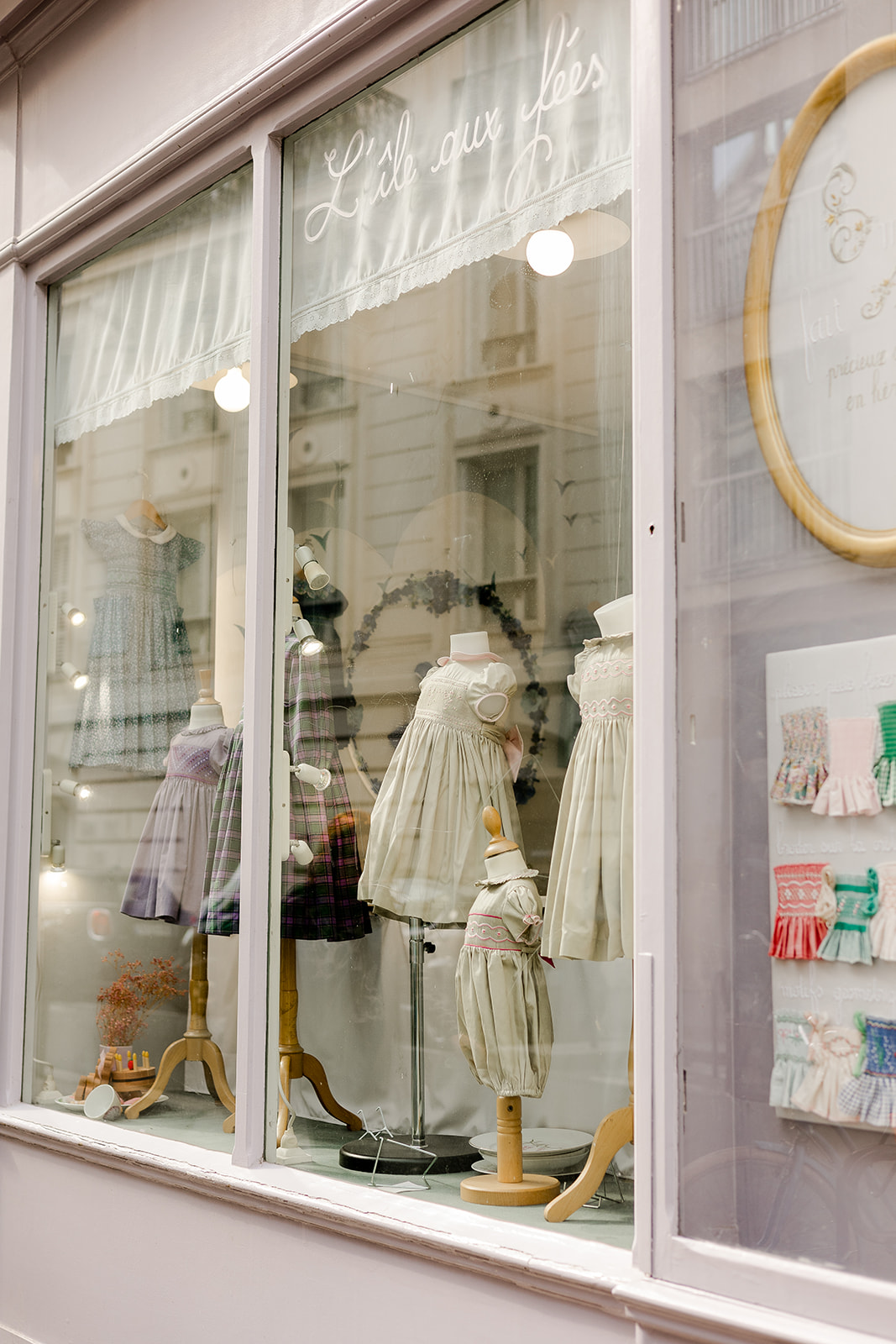 Handmade smocked dress, display in luxury Parisian children's boutique L'Île aux Fées