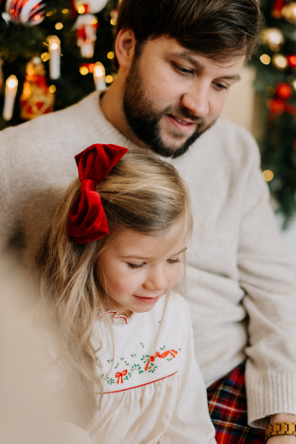 Father and daughter sharing a special moment in a French children's dress