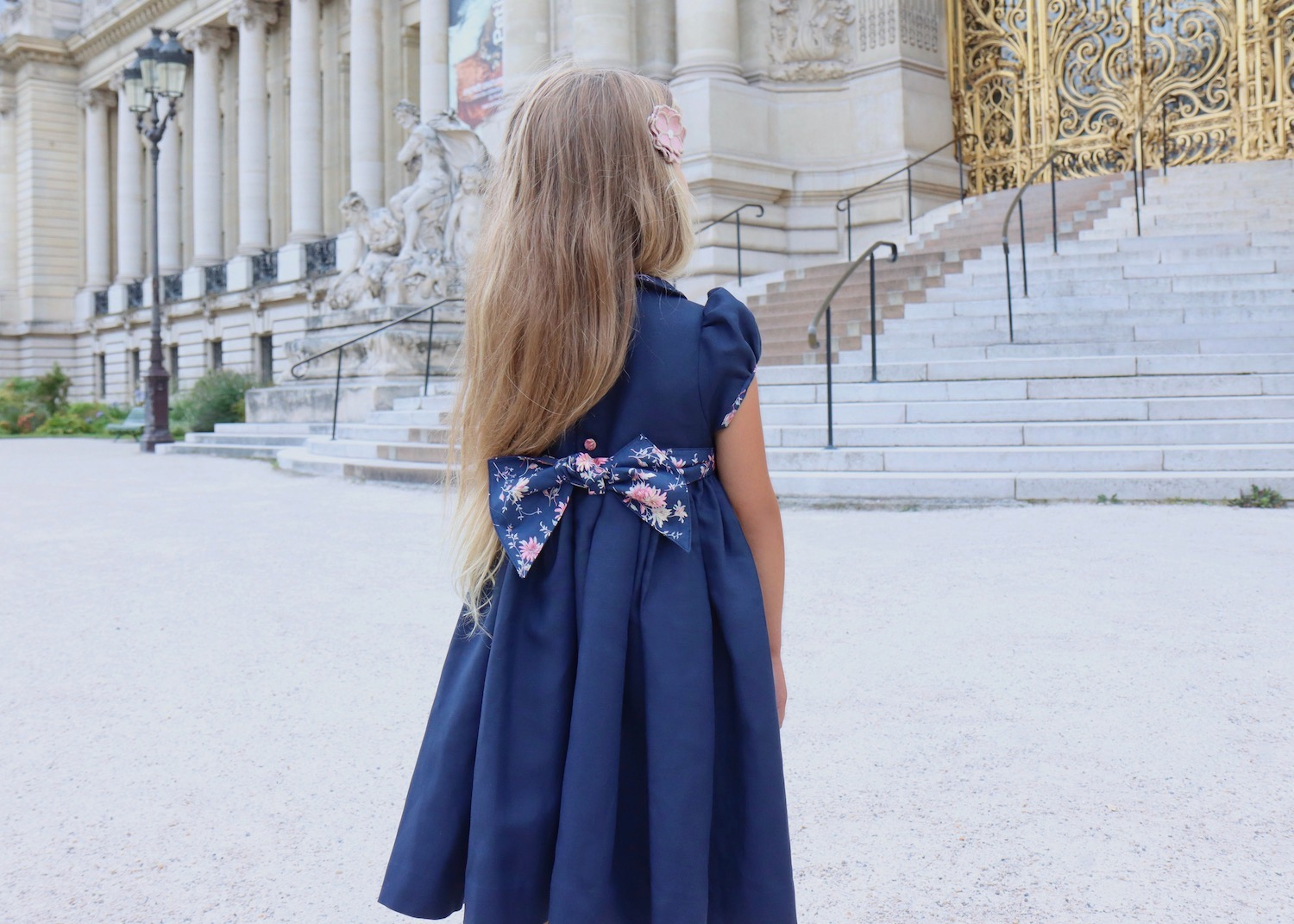 Little girl in a classic smocked French dress, timeless French style, L’Île aux Fées Paris boutique