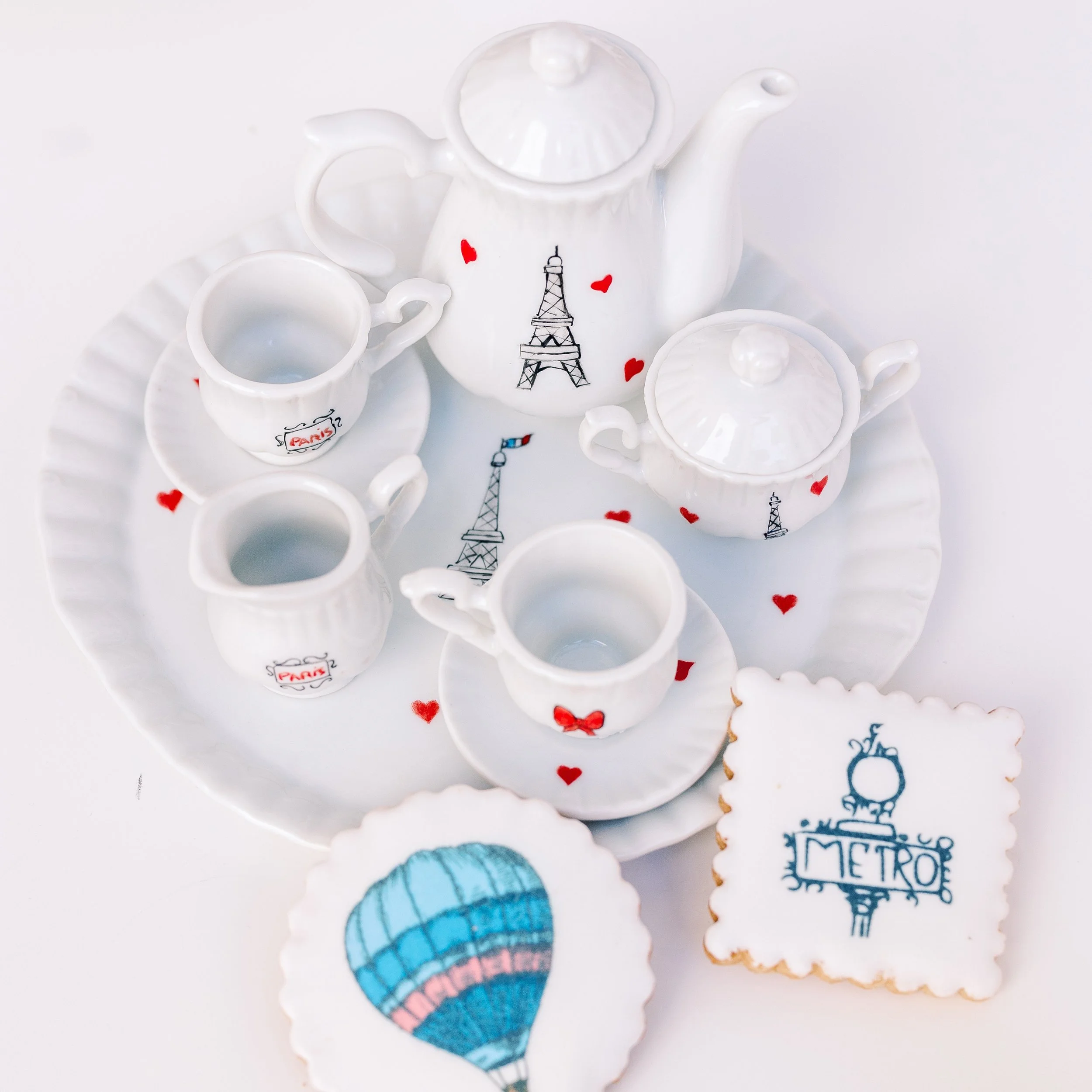 Miniature porcelain tea set with Eiffel Tower and Paris street motifs