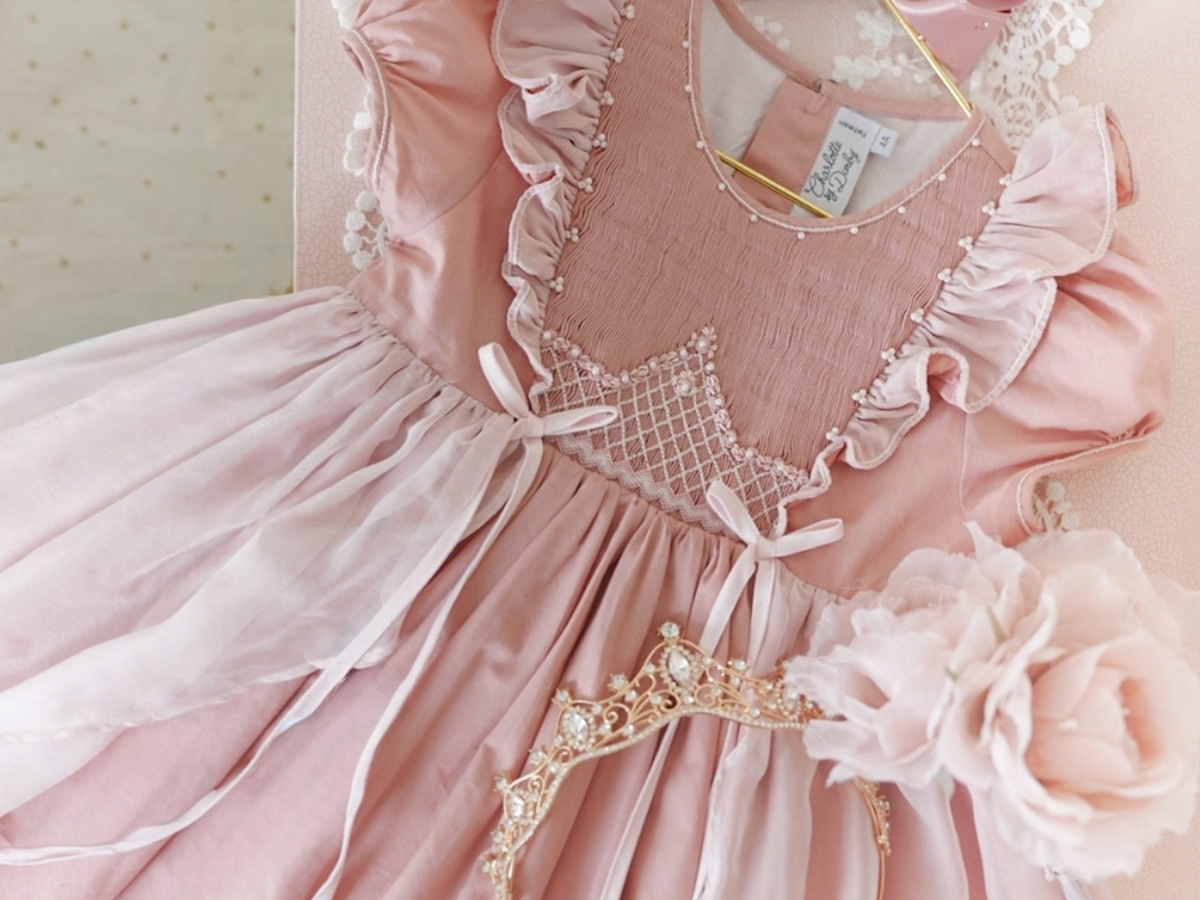 Hand-embroidered smocking detail on a girl's summer dress, made in the atelier