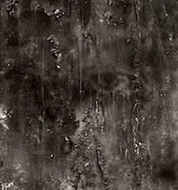 The final part of the triptych peers out through layers of burnt wood, embers and charcoal dust 