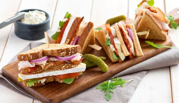 Club sandwich quarters on wood cutting board