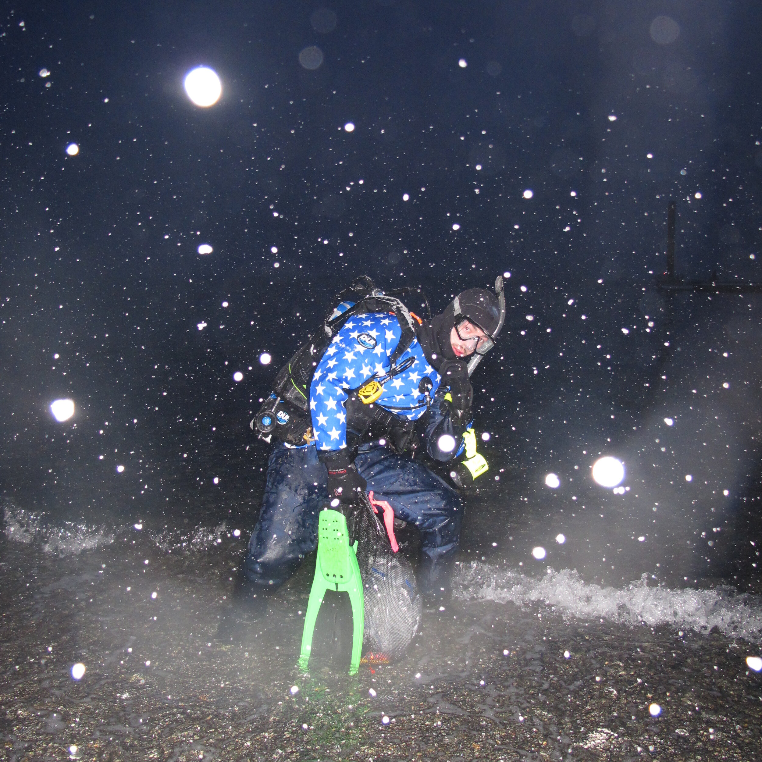  Entering the water for a night dive in South-Central Alaska during a spring snowstorm. 