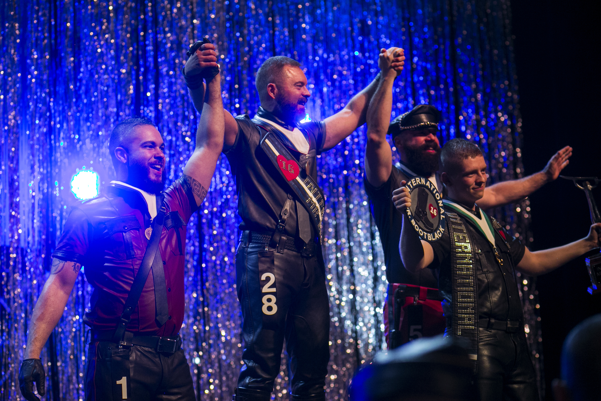  Adam Henderson, far left, third place, David Bailey, middle left, first place, Todd Harris, middle right, second place, and Erick Joseph, far right, winner of Mr. Bootblack, celebrate during the conclusion of The 38th Annual International Mr. Leathe