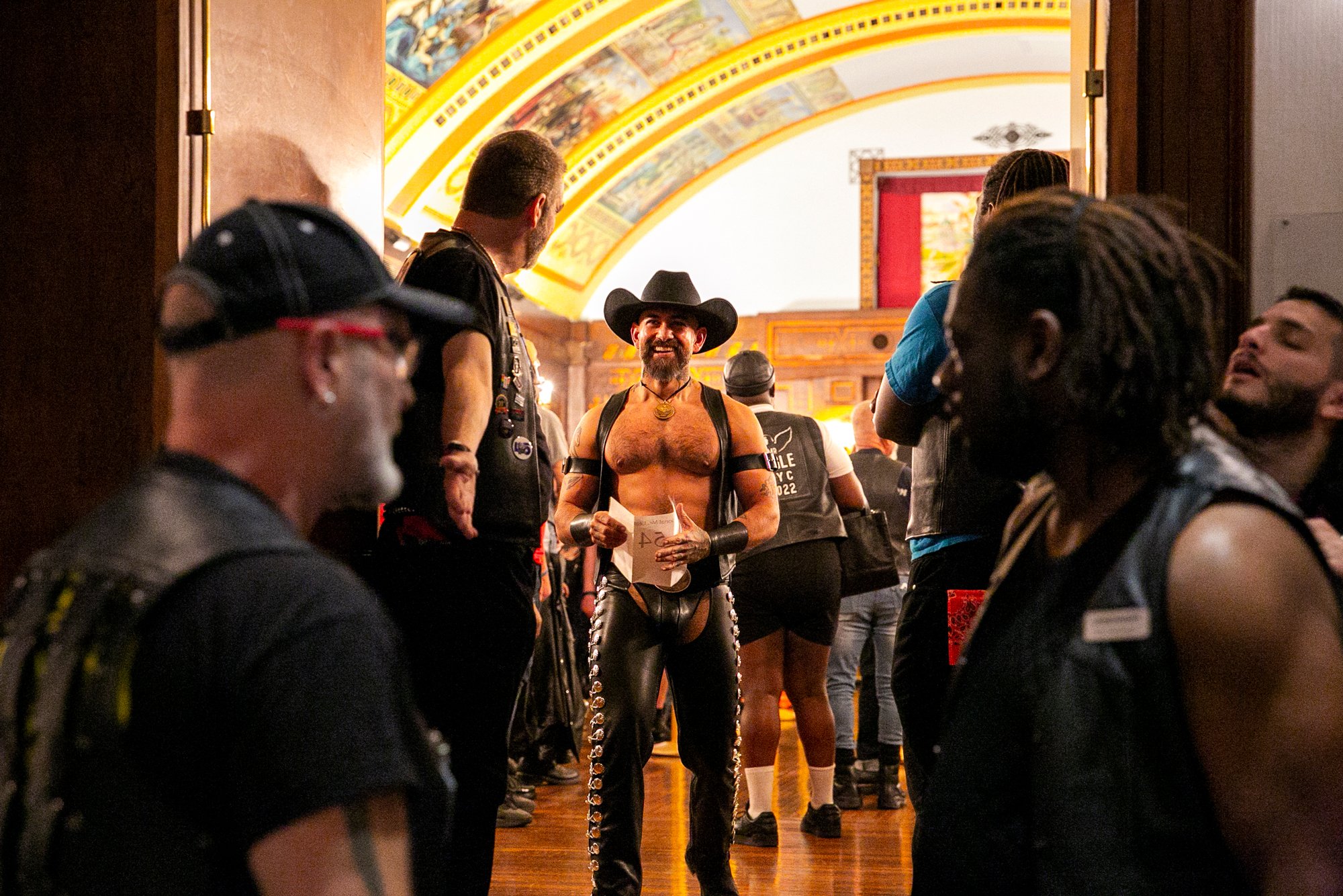  Marcus Barela, Mr. Eagle LA 2020, leaves the Florentine Room after receiving his competition number during the  Opening Ceremonies of International Mister Leather 45, held at The Congress Plaza Hotel, Thursday May 25, 2023, Chicago, IL.  Barela even