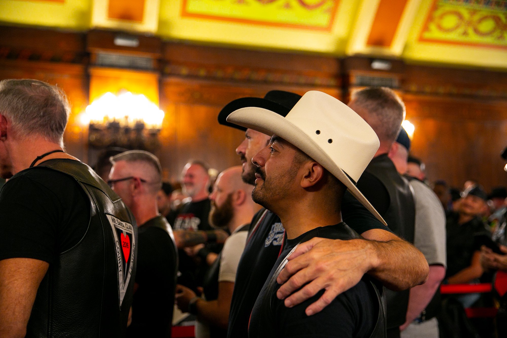  Sam puts his arm around his fiancé, Oscar, during the Opening Ceremonies of International Mister Leather 45, held in The Florentine Room at The Congress Plaza Hotel, Thursday May 25, 2023, Chicago, IL.   On Saturday the two will be married in the ve