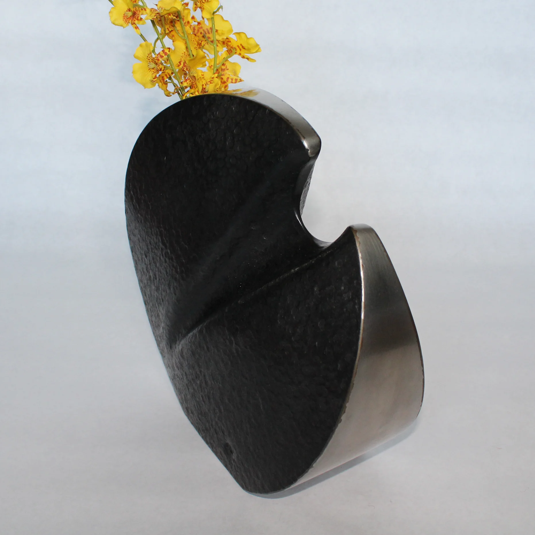 design + metalwork by bart turner medium: mild steel + stainless steel size: 10” x 3.25” x 10.5” capacity: 100 cubic inches price: $3,500.00 notes: self-contained stainless steel bud vase.