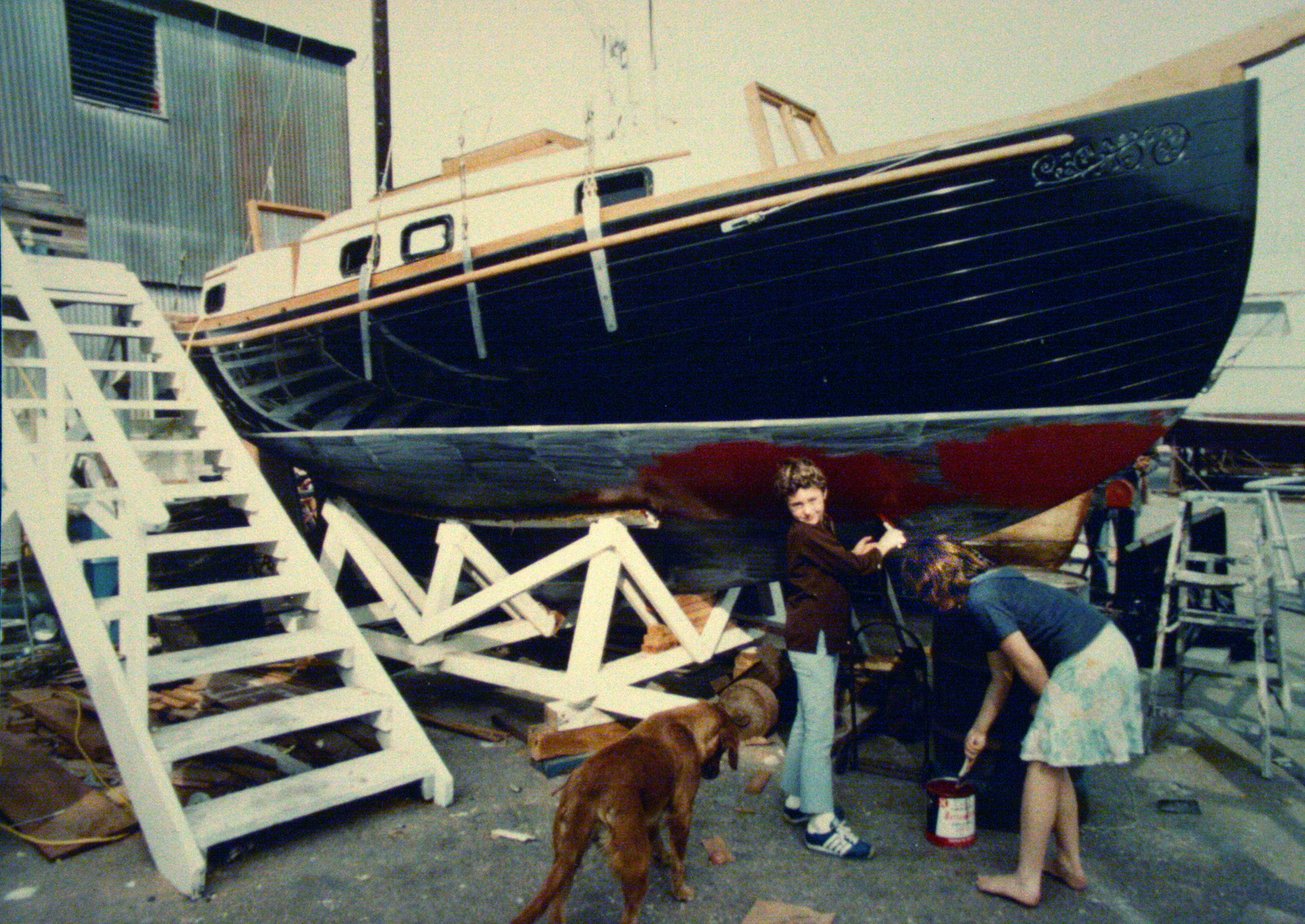 Ted and Jackie painting the bottom our finished boat - Sea Shanty