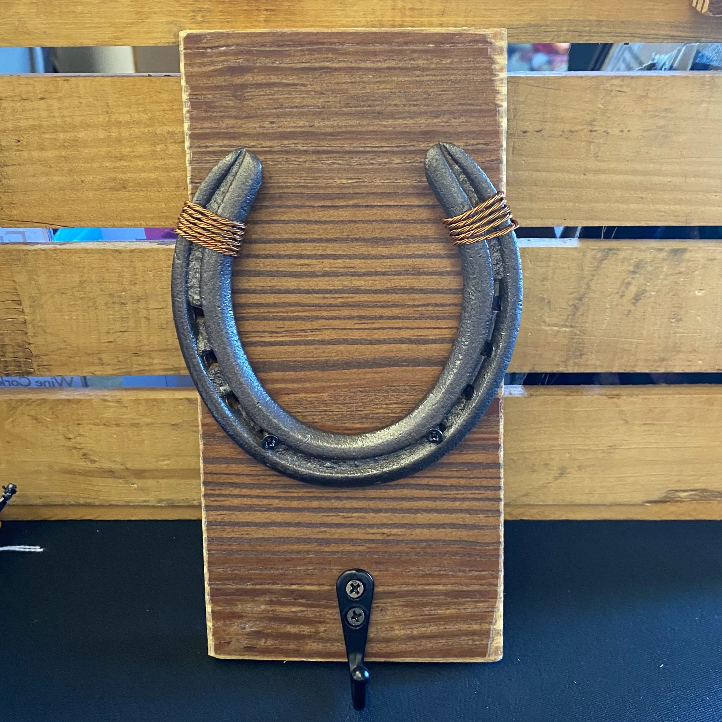 Horseshoe on wooden board with hook
