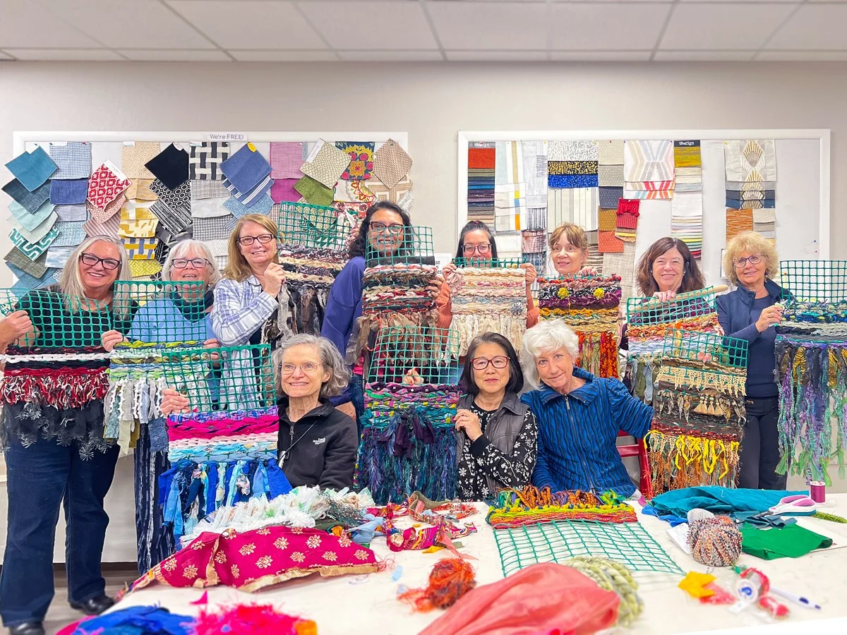 Group of women displaying their weaving projects