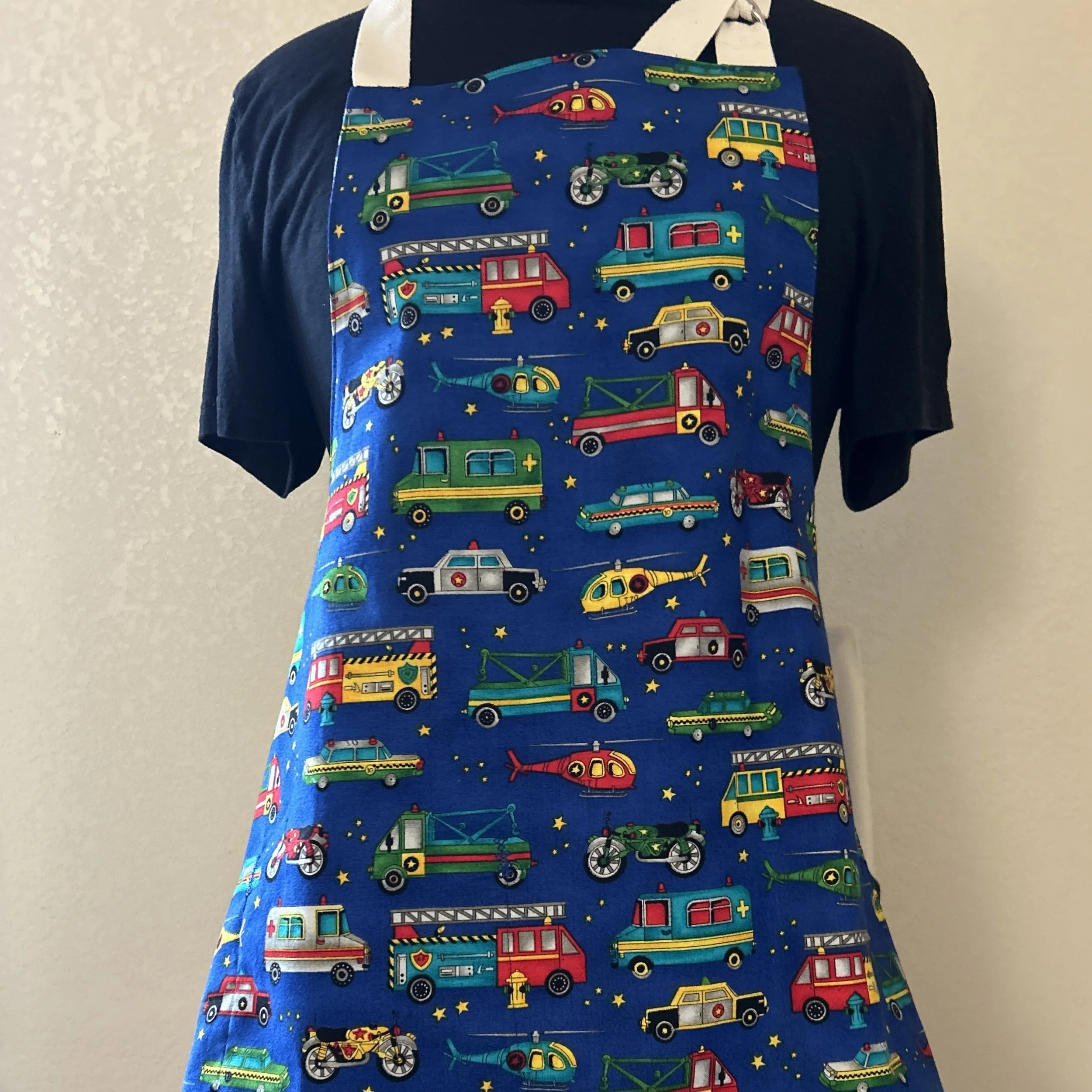 Apron with transport vehicle graphics on blue background