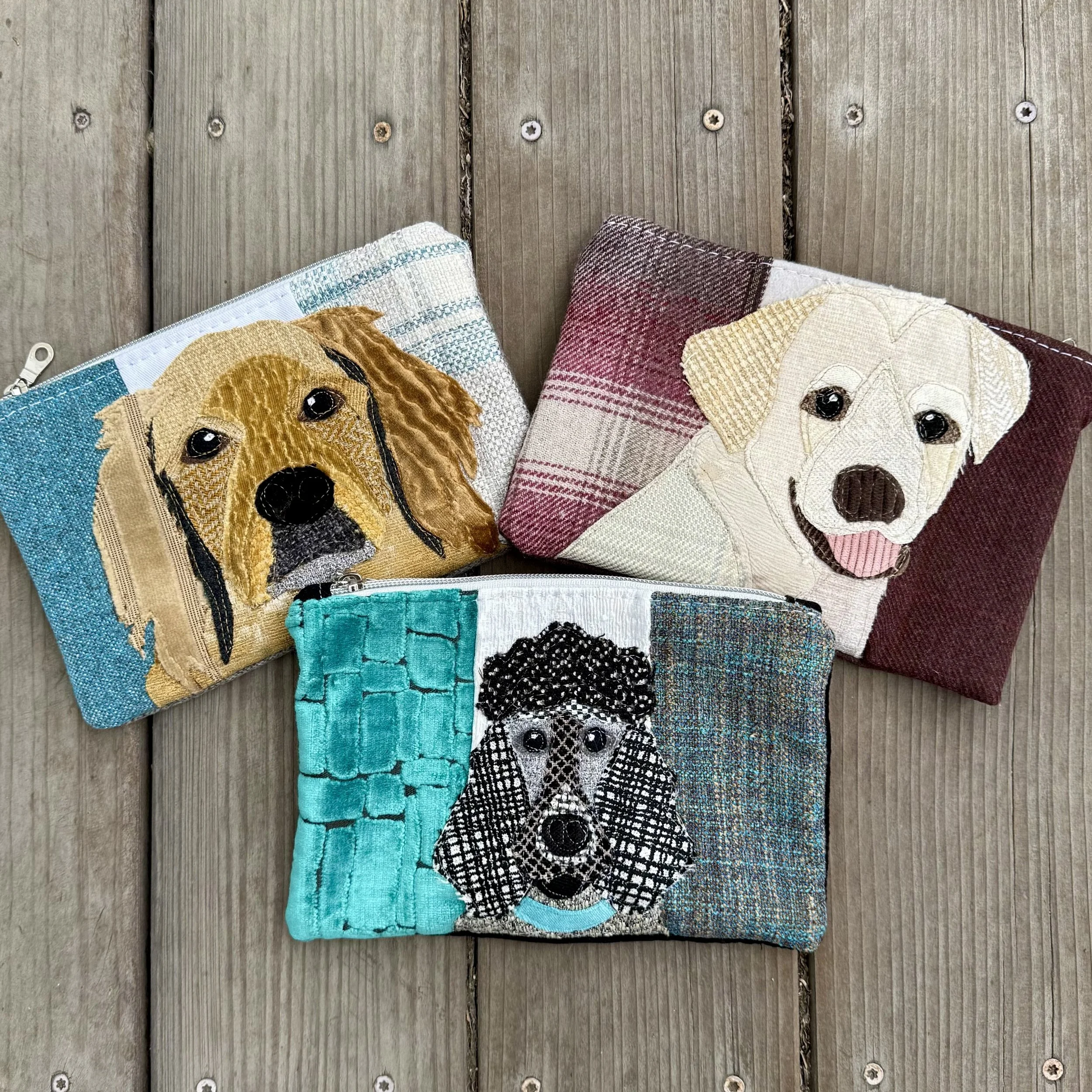 Three zipper pouches with dog appliqués