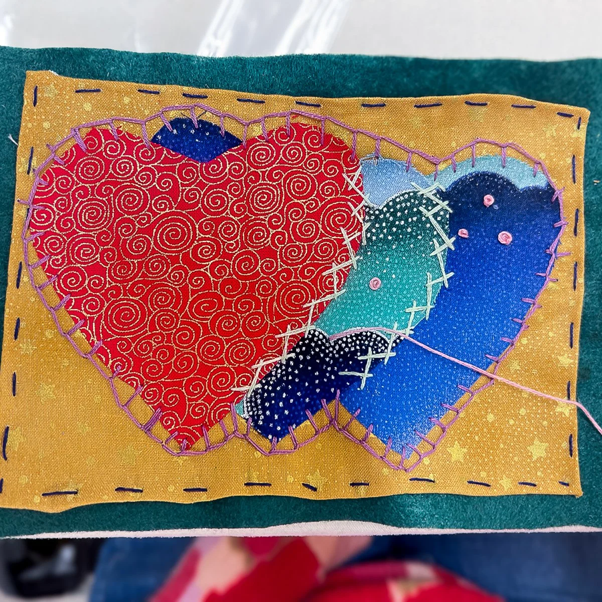 Triple fabric heart design sewn on yellow background