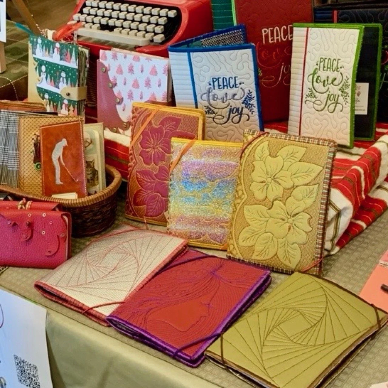 Assorted handmade journals in warm red and yellow tones