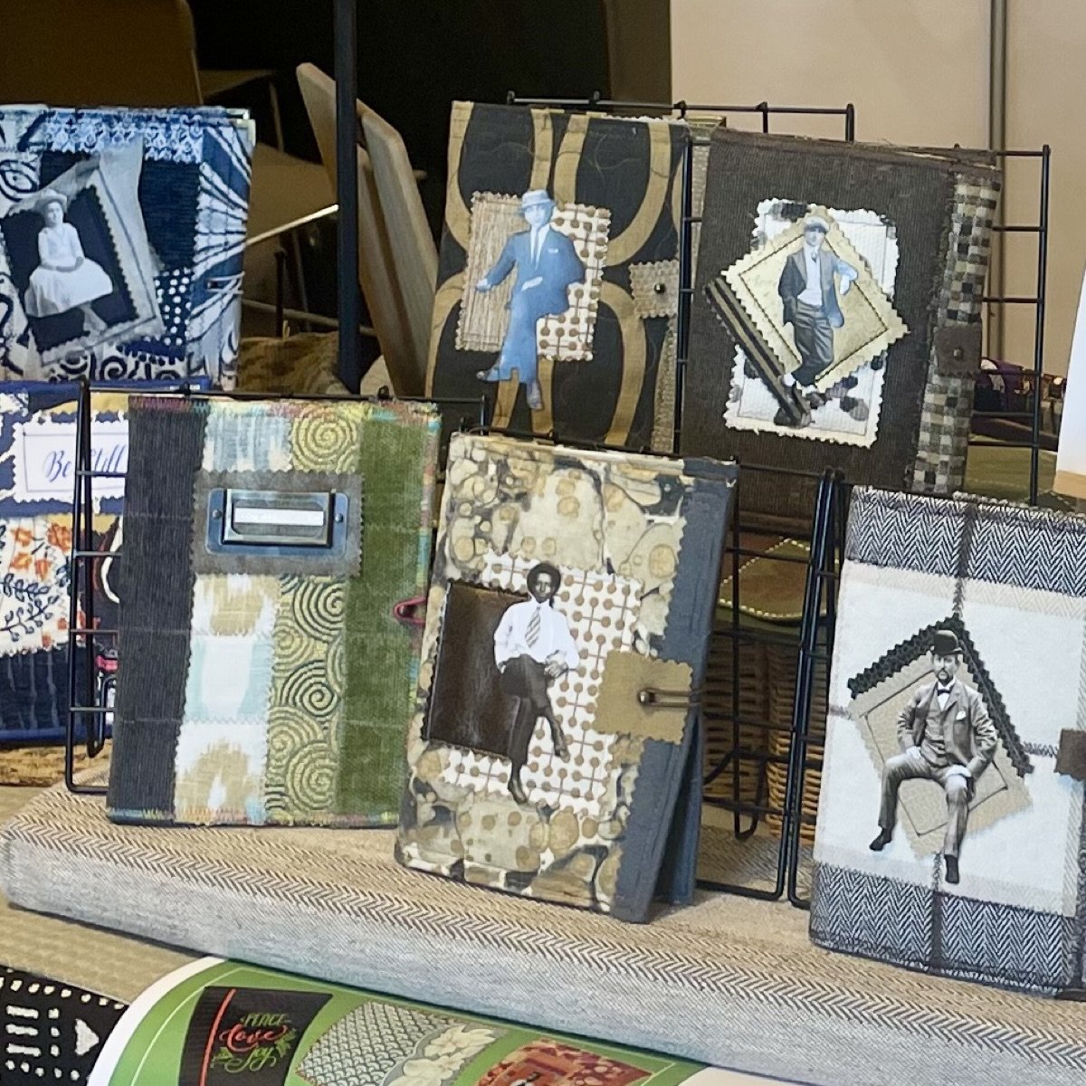 Assorted handmade journals in greys, blues, and green