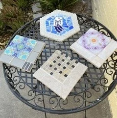 Four tile mosaics on garden table