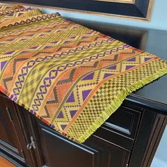 Yellow fabric runner with geometric designs