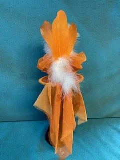 Back view of hat with orange and white feathers