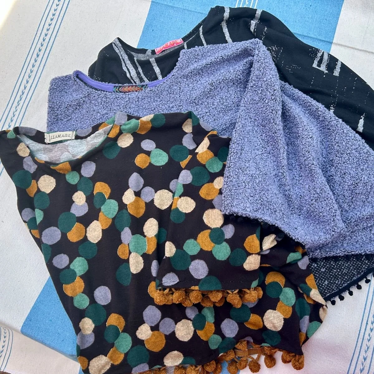 Pile of three folded ponchos