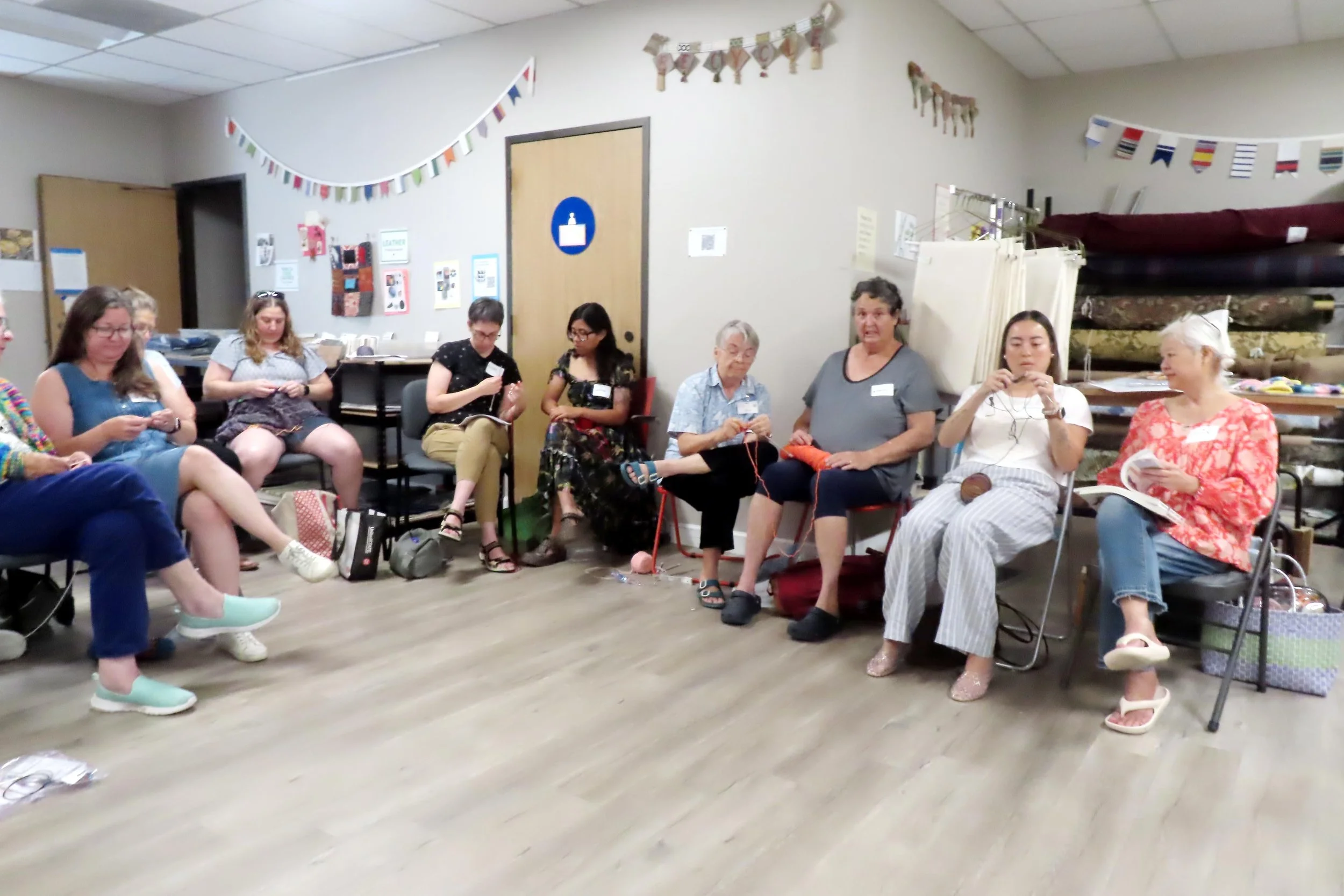 Group of seated women knitting
