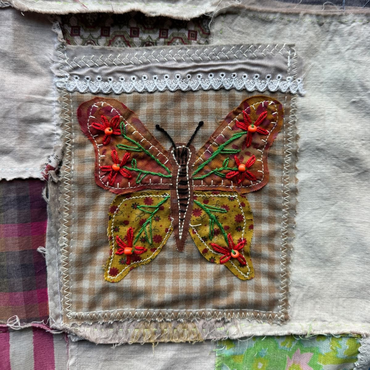 Embroidered butterfly stitched on fabric square