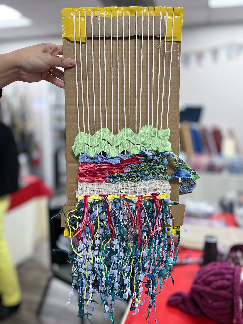 Cardboard loom with weaving