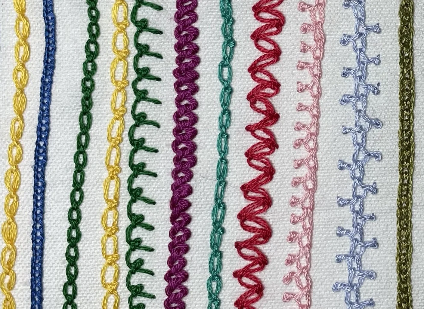 Sample embroidery stitches on white fabric