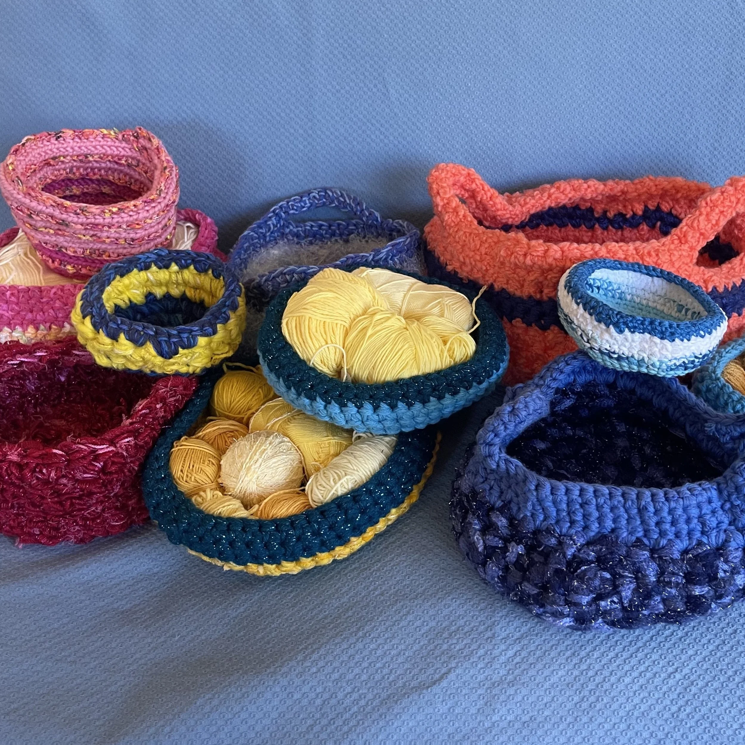 Assorted multicolored crocheted baskets