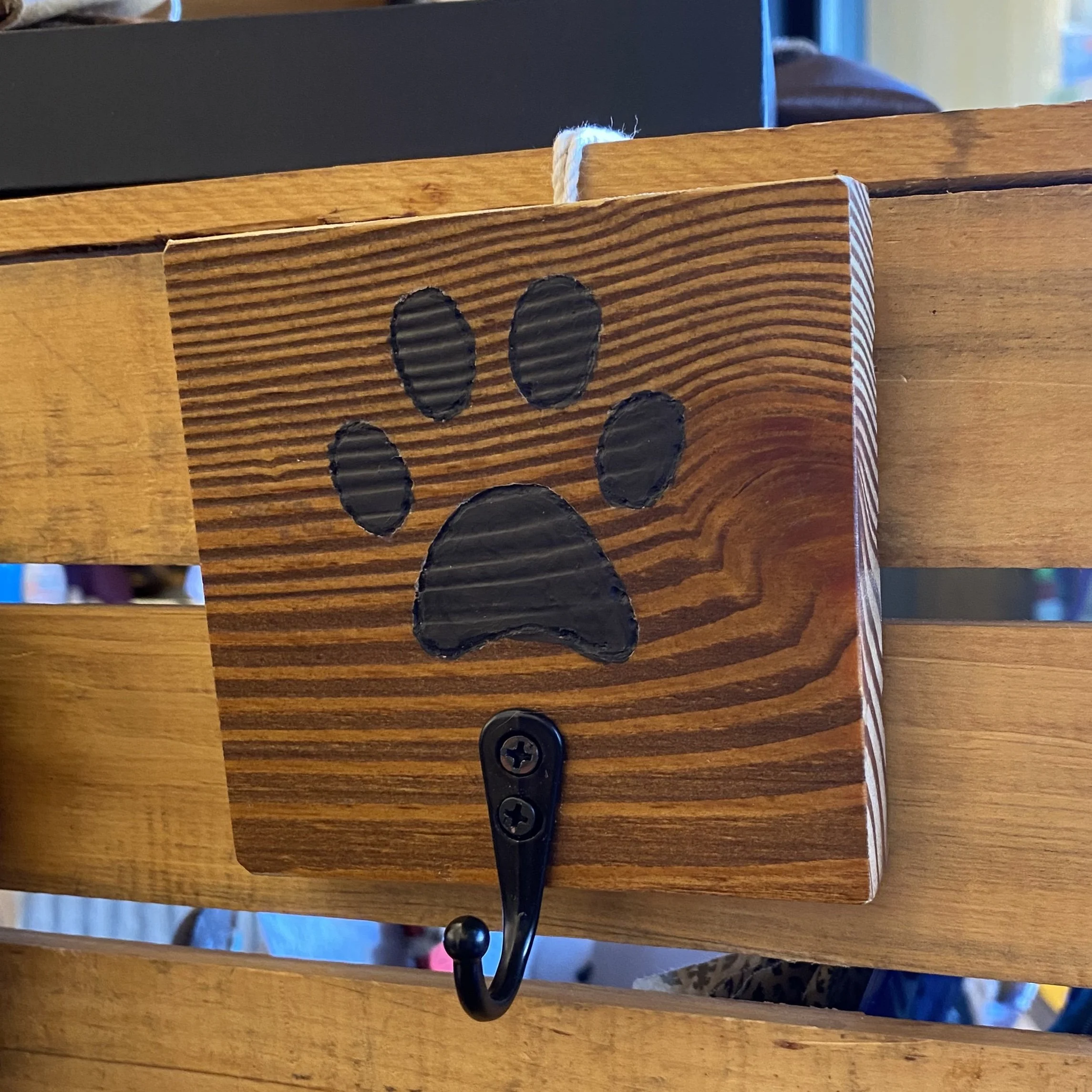 Paw print on wooden board with hook for hanging clothes or keyring