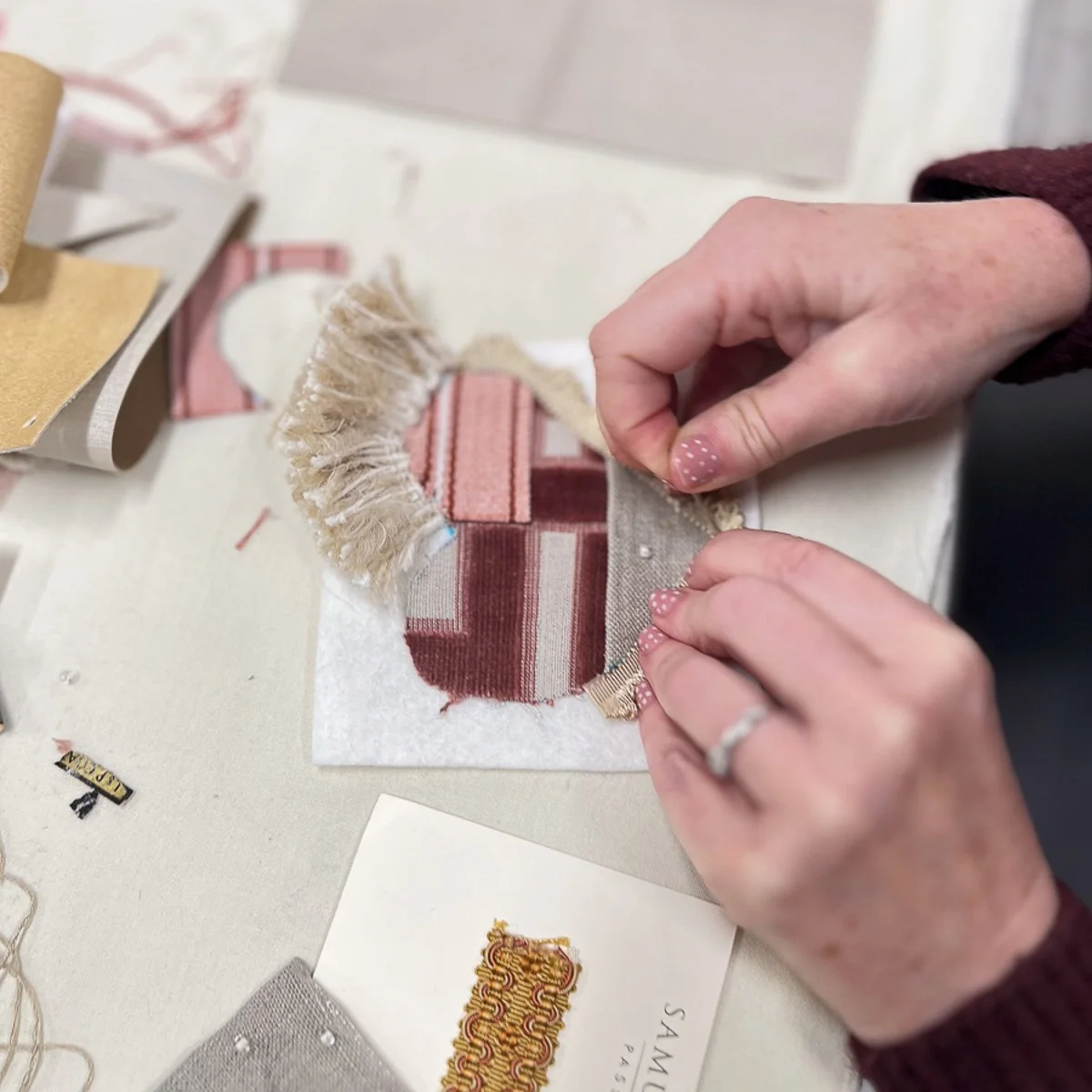 Person's hands working on sewing fabric heart