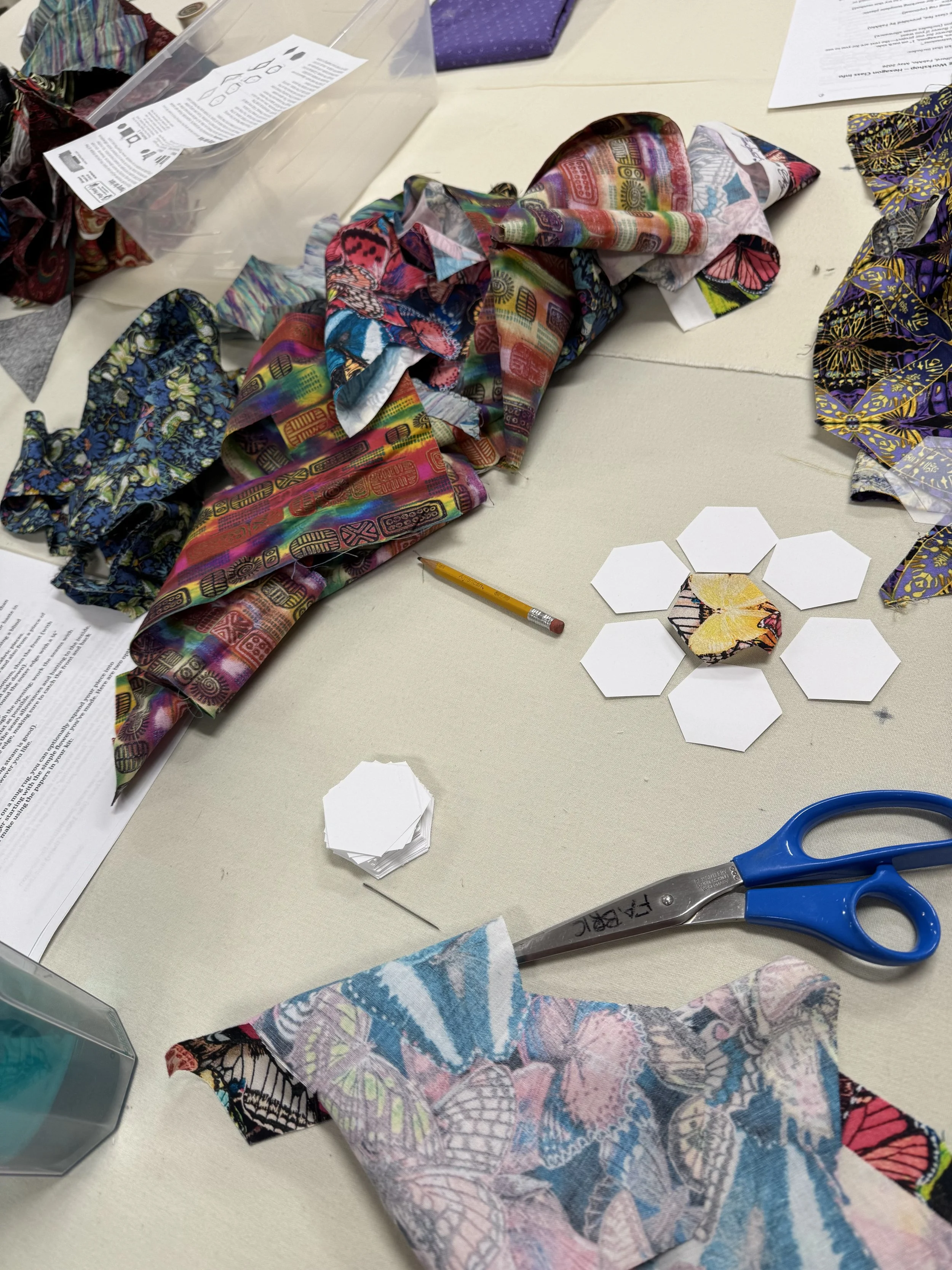 Colorful pieces of fabric and scissors on tabletop