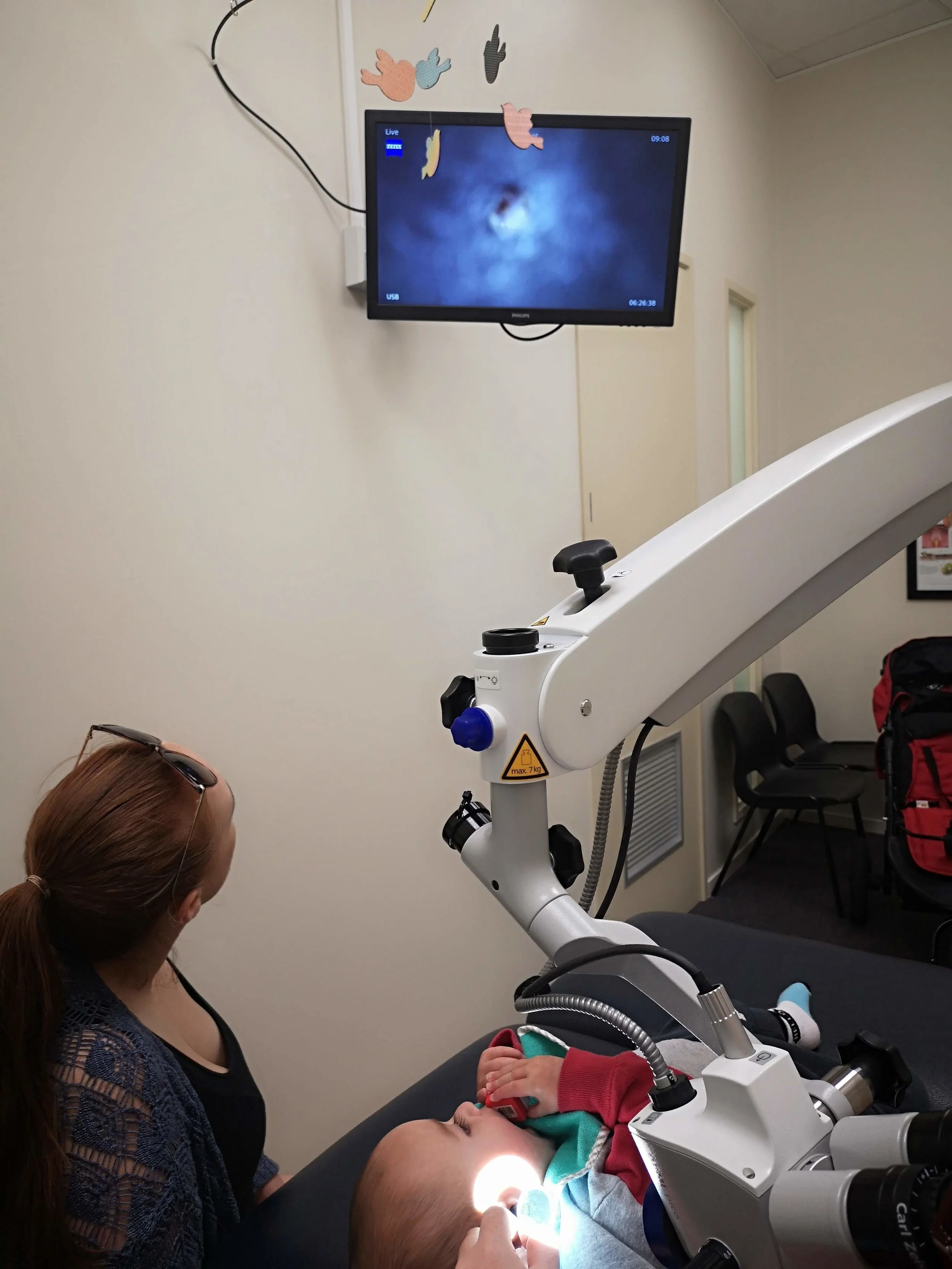 Wyatt having his ears examined under the microscope while mum can see on the screen what his ear is looking like
