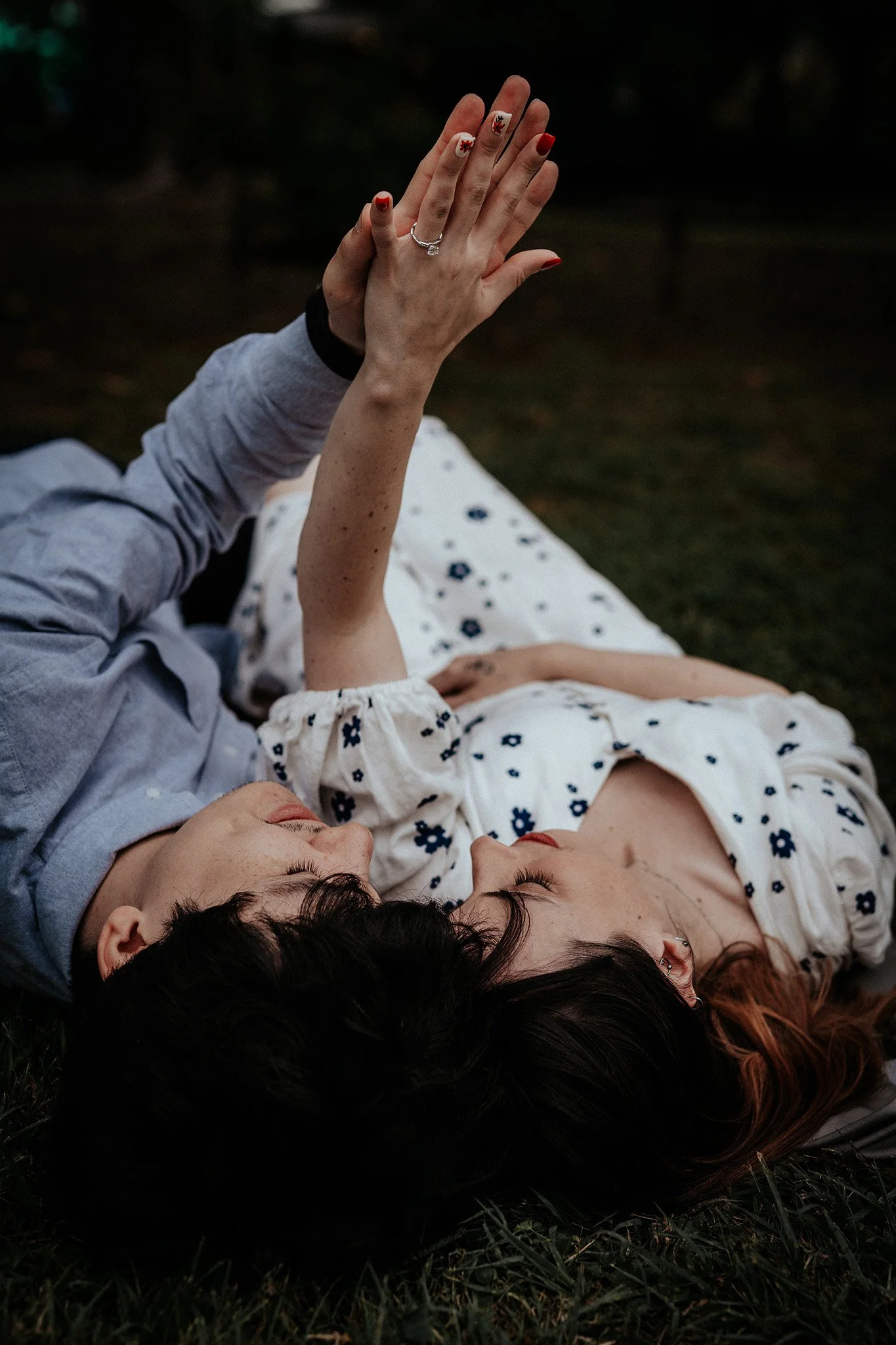Tokyo engagement couple lying down and admiring their engagement ring 