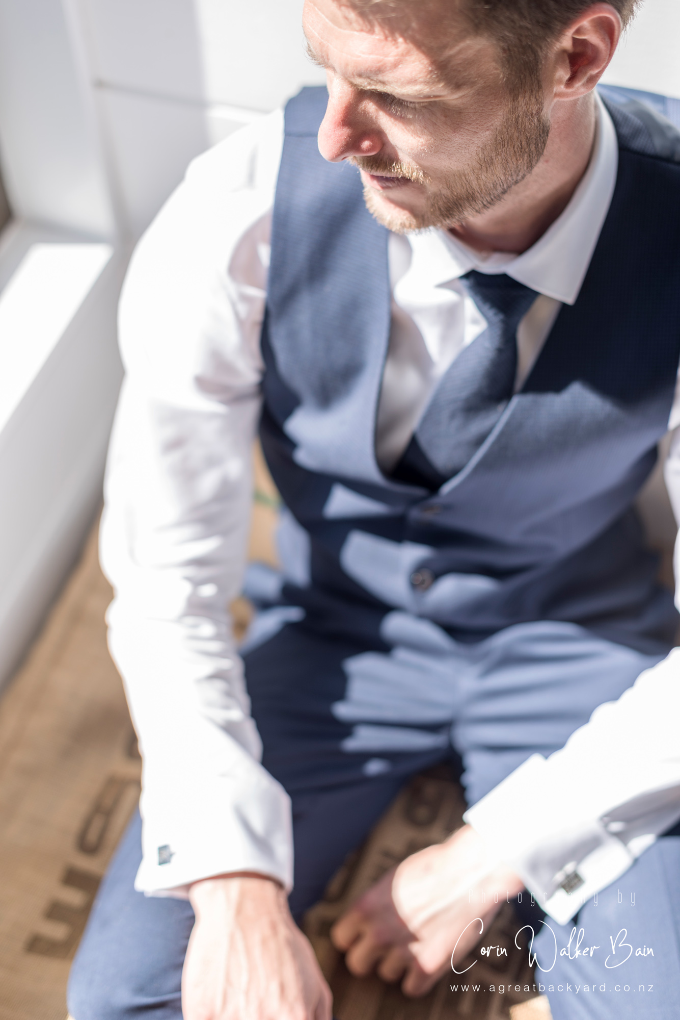 Portrait of the groom at Andy and Emma's Waiheke Island wedding by New Zealand wedding photographer Corin Walker Bain of a great backyard