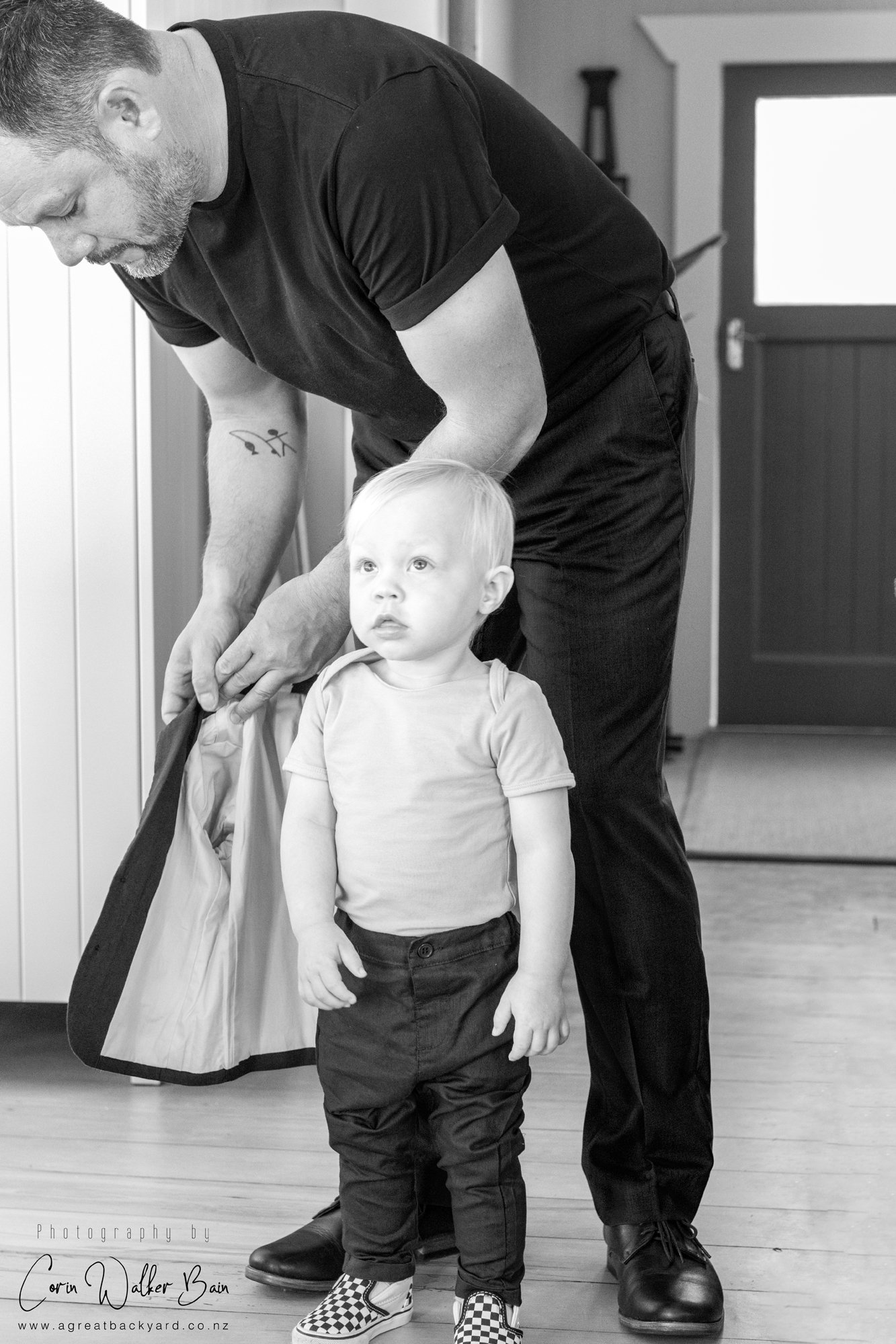 Groom dressing his son 