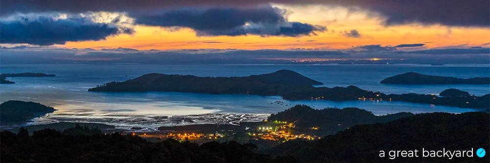 View across sparkling lights of Coromandel Town at night by Corin Walker Bain | a great backyard