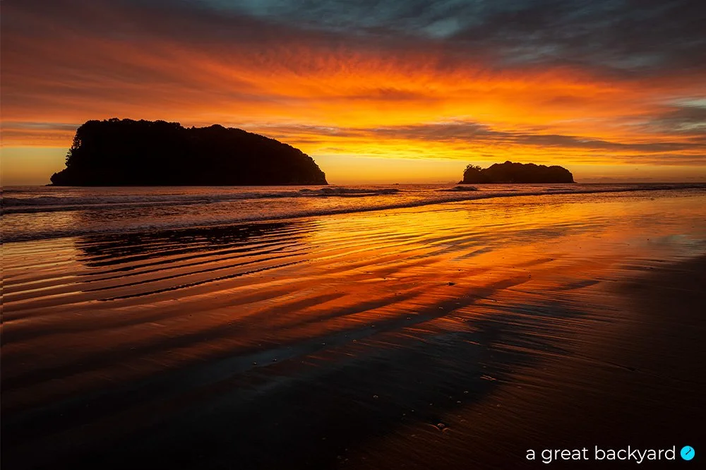 Crimson dawn over Whangamata Beach, Coromandel, New Zealand