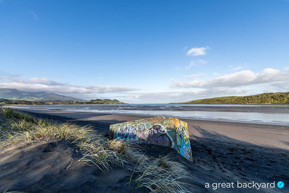 View across graffitied bunker on Raglan beach in morning light by Corin Walker Bain | a great backyard