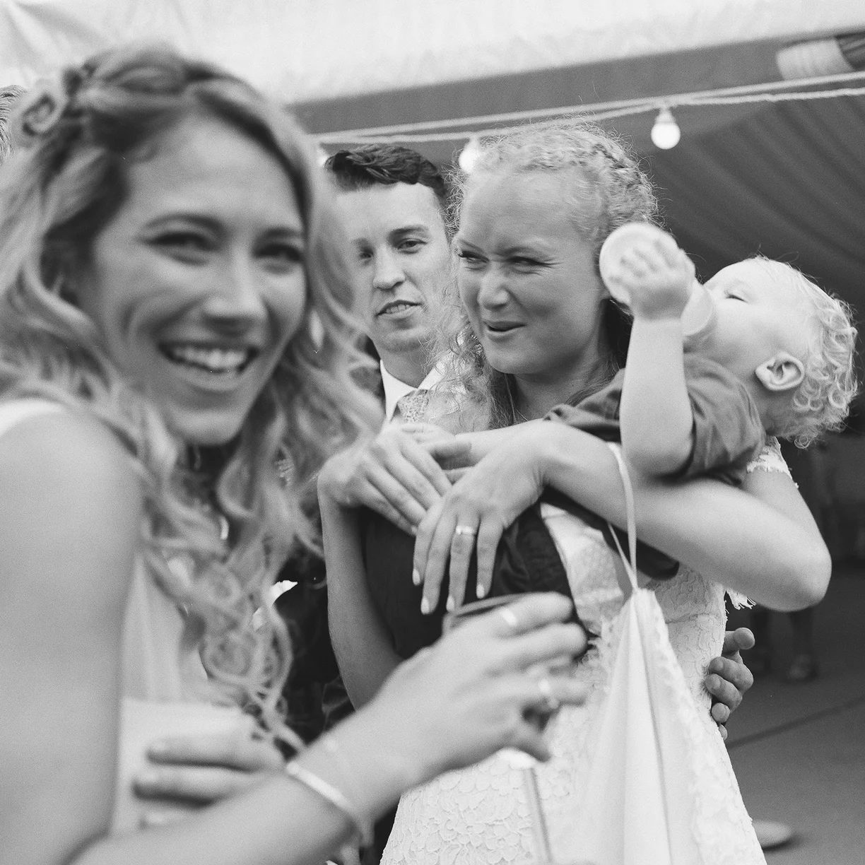 Film wedding photography. Bride and groom and baby.