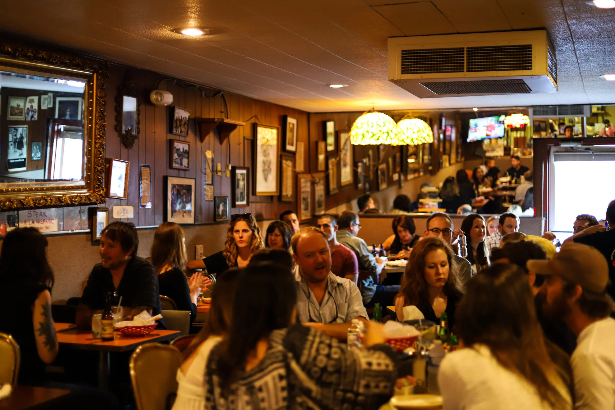 Cisco's dining room packed with guests enjoying the expanded menu. The dining room's eclectic decor gives the restaurant the perfect homestyle feel.