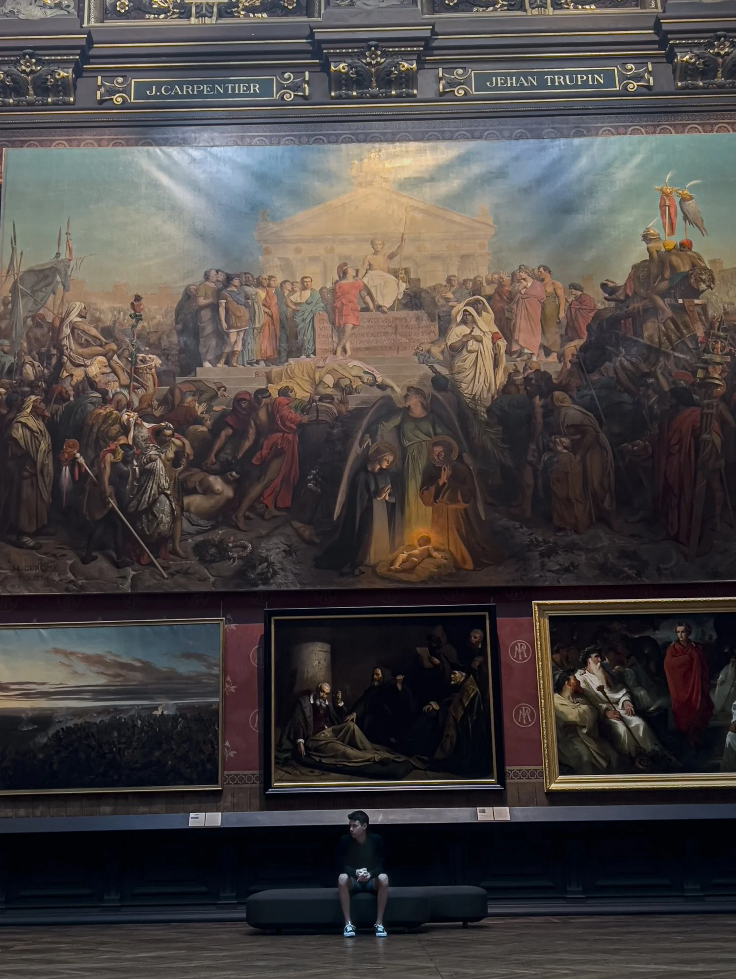 man sitting on bench museum mural .jpg