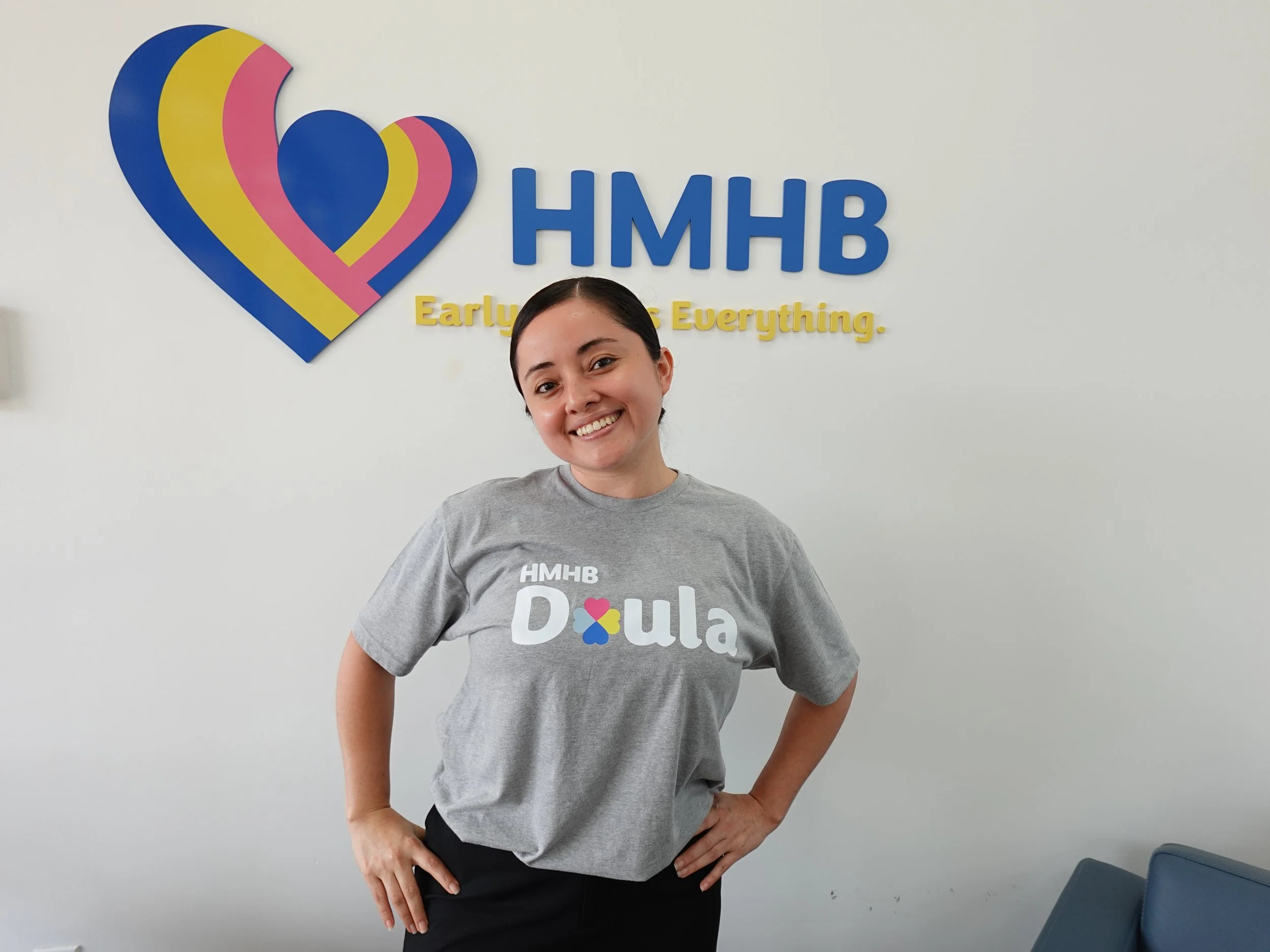 Stronger Together Doula posing in front of HMHB sign