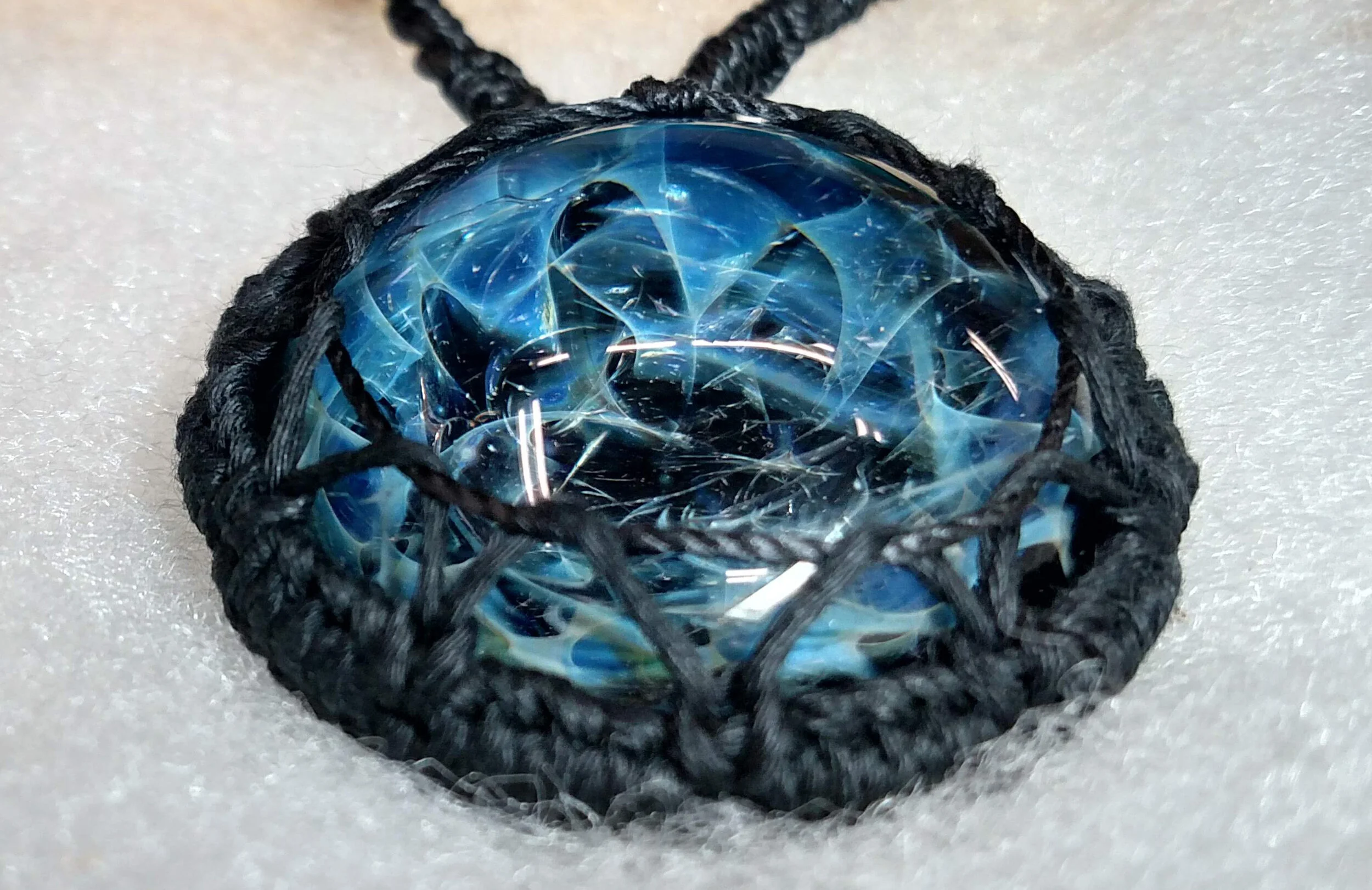 This is a process photo showing the depth and detail of this lampwork glass made by a friend, whose work can be found on Instagram @entropyglass