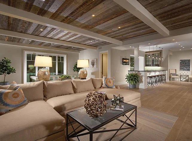 I love the idea of adding interest to the basement ceiling to give it less of a basement feel and more of a true living space. This coastal home by Brandon Architects did a truly amazing job with those beams and reclaimed wood!