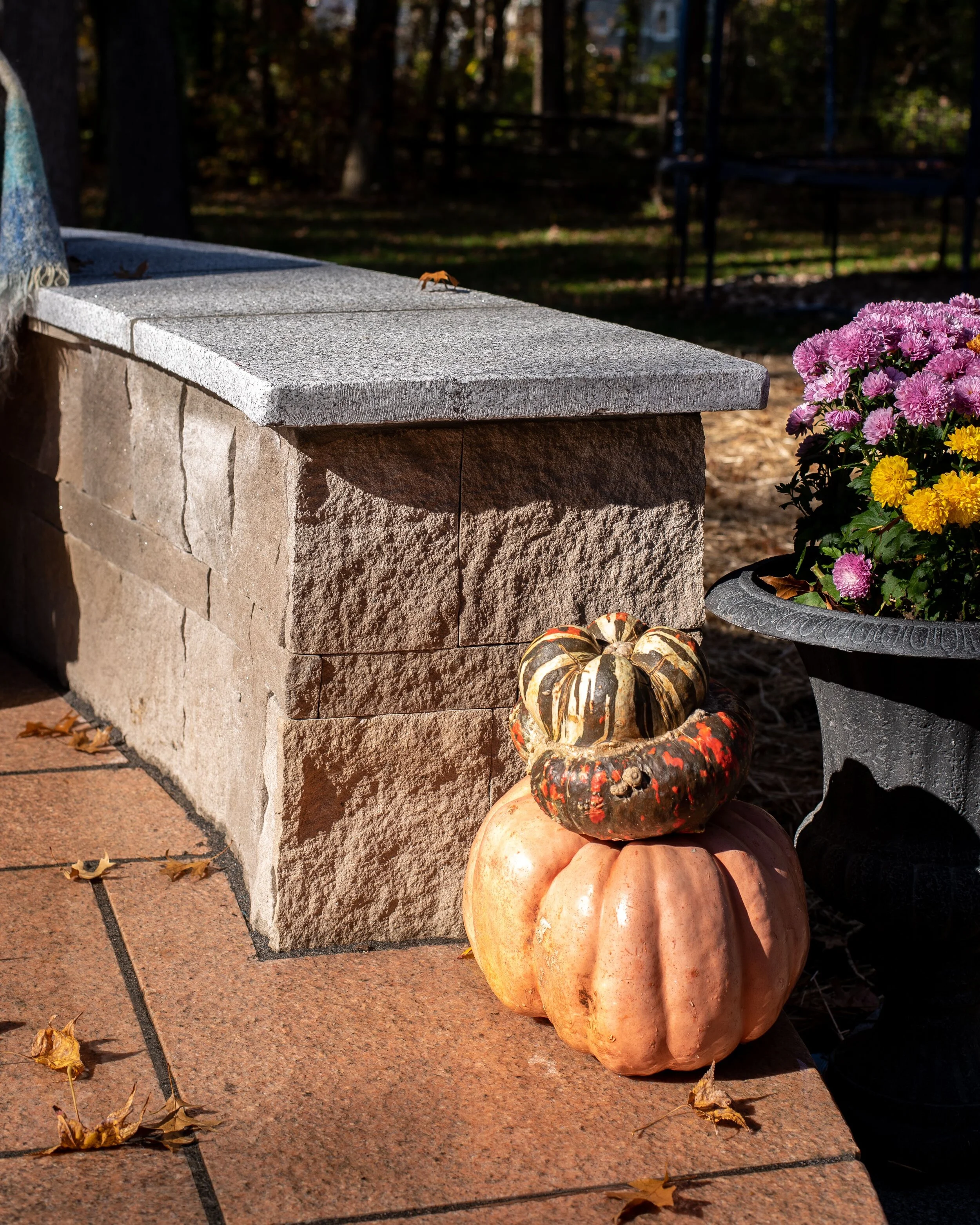 We used Carolina Coral granite for all of our pavers. The firepit wall, sitting wall and outdoor kitchen were built using Indiana Limestone Full Blend and all of the caps are Woodbury Gray granite.