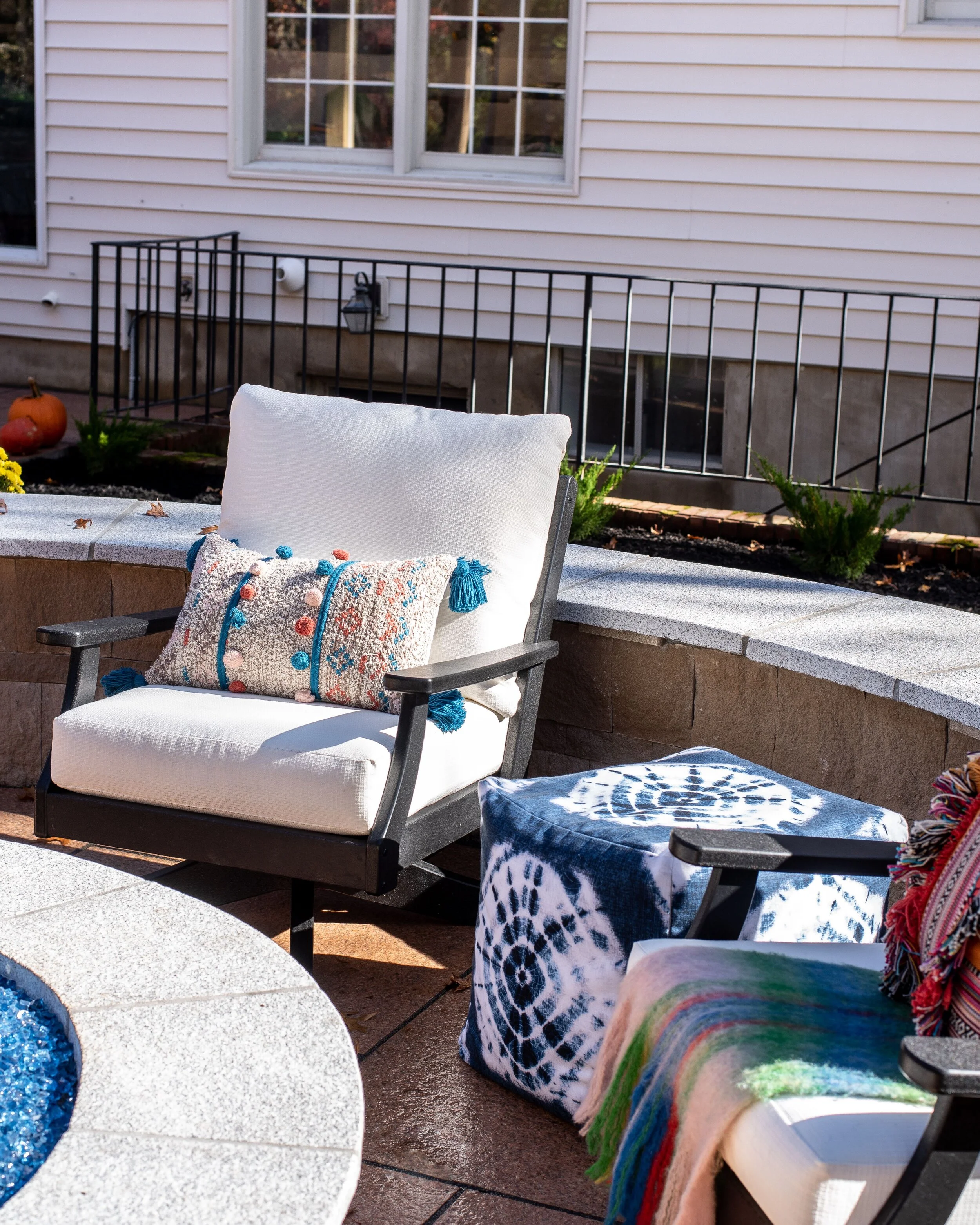 For the firepit seating I wanted guests to be able to turn to look at kiddos playing on the trampoline or ping pong, chat with friends at the dining table or see what’s going on at the bar.  I also didn’t want people to be sitting super low to the g…