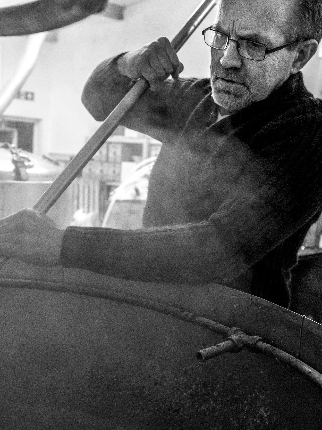 A focused Dave stirs the mash at his small Penryn Brewery Photograph by Morgan Webb