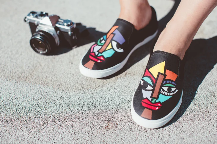Each shoebox comes with a card describing the artist's inspiration, where they're from, a picture of their artwork, and contact details.