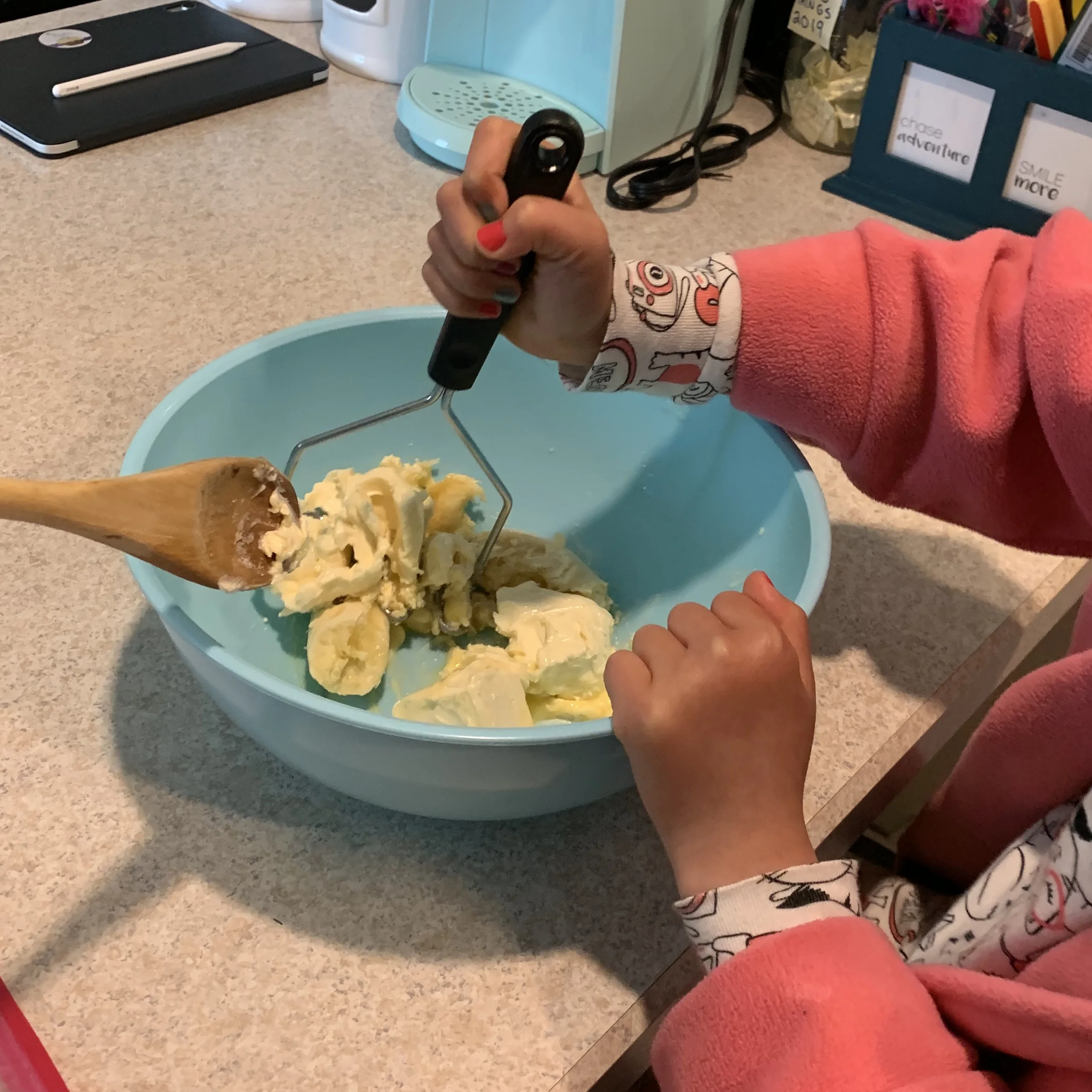 Mashing the banana and margarine together.